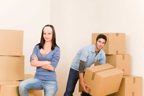 Mover carrying a boxed item through a property entrance