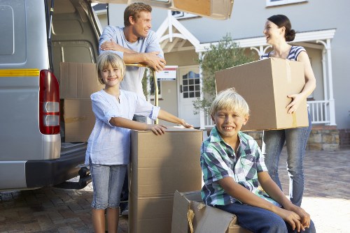 Professional movers loading furniture into a vehicle